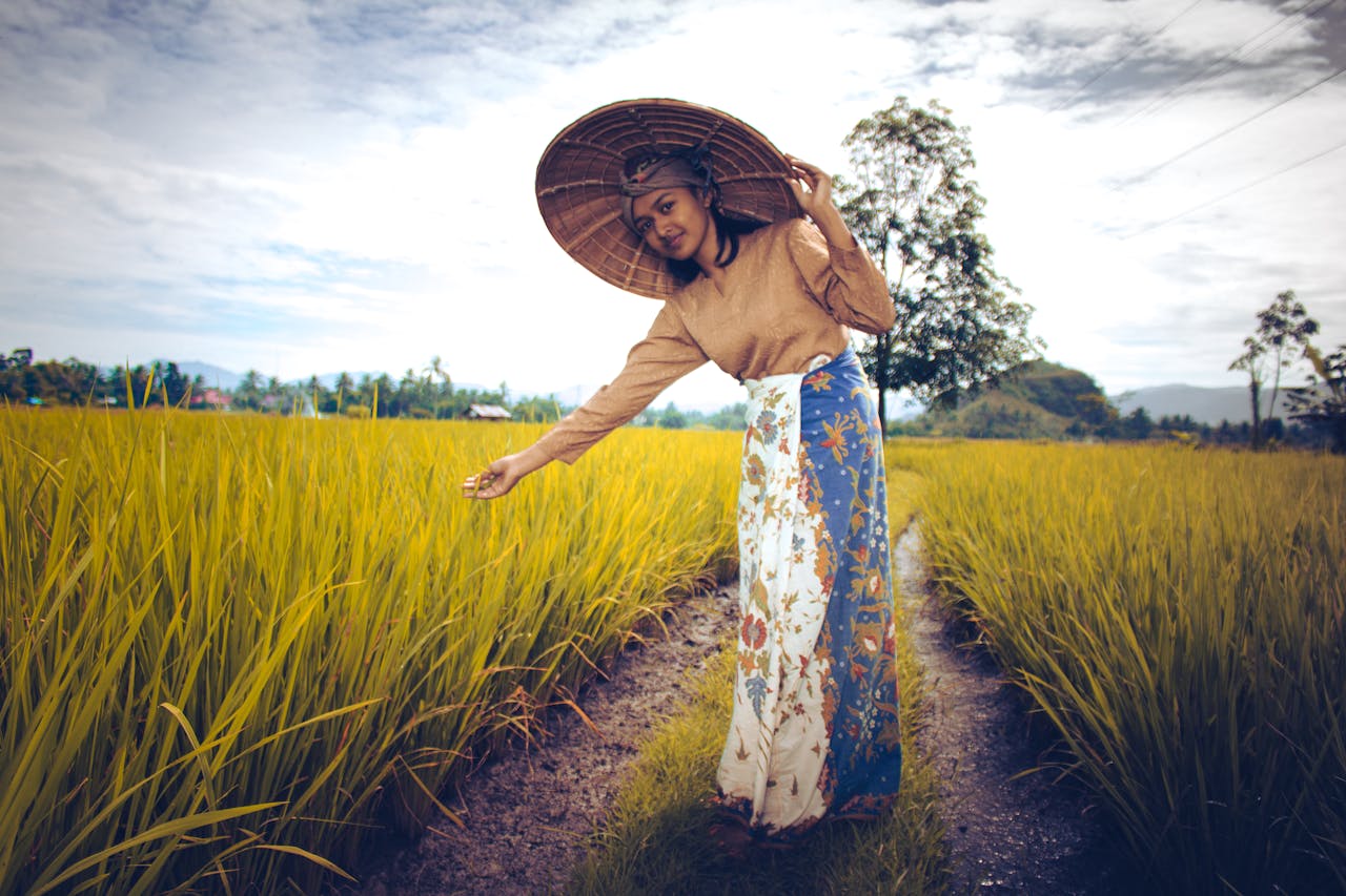 Woman Wearing Brown Long-sleeved Top And White And Blue Skirt Near Green Plants